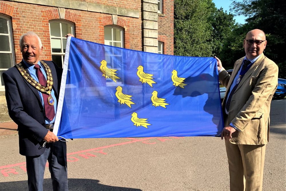 HDC Chairman Cllr David Skipp and Vice Chairman Cllr Nigel Emery prepare to raise the Sussex Day flag