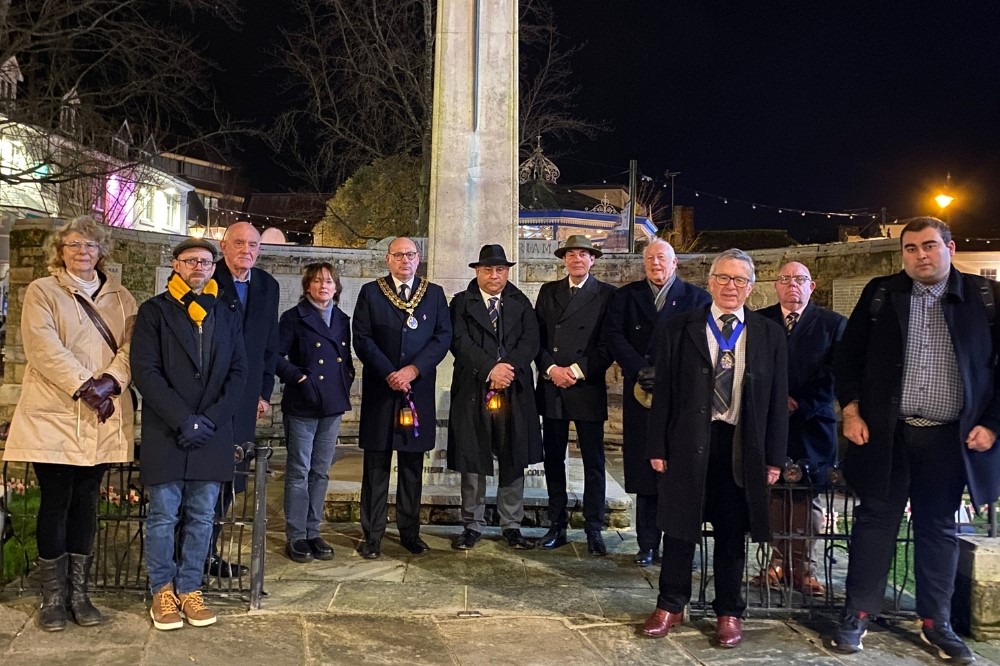 Horsham District councillors and members of the Horsham Branch of The Royal British Legion stood in front of Horsham Carfax War Memorial. 