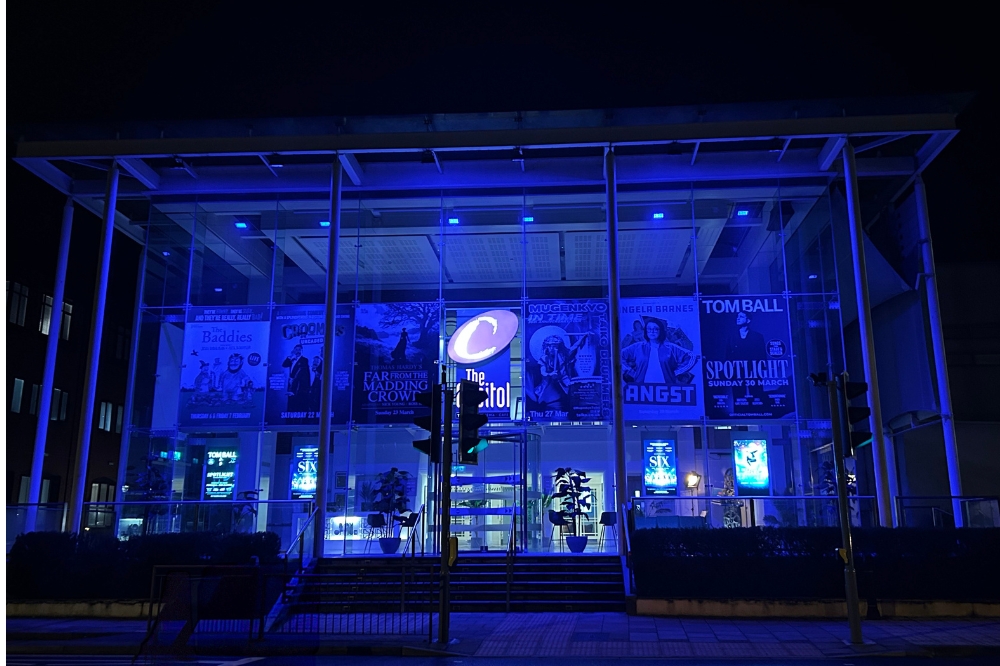 Capitol frontage illuminated with blue lighting at night