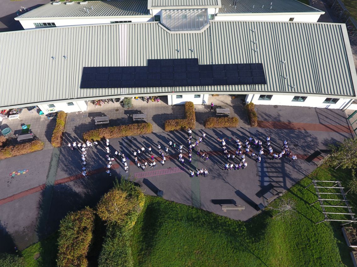 Picture of Barns Green Primary school children organised into a Thank you, viewed from above the school, allowing the new solar panels to be seen 