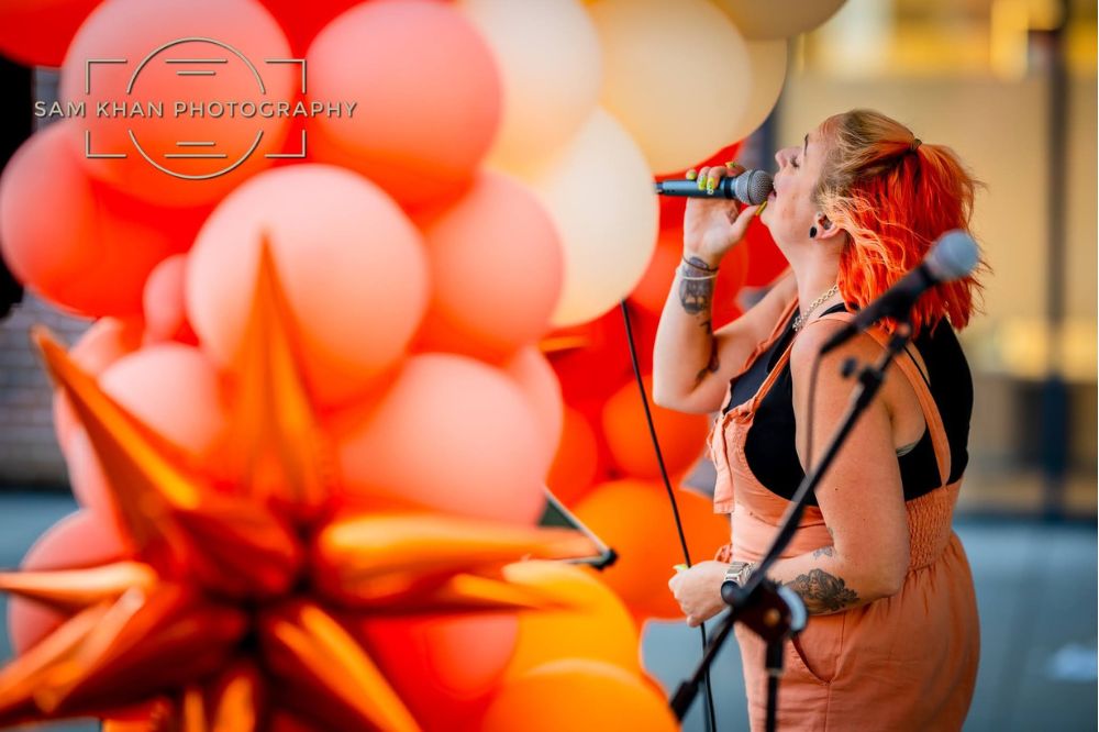 Singer wearing orange dungarees