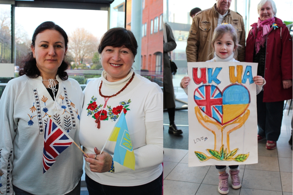 Adults and children attending the event with flags and artworks