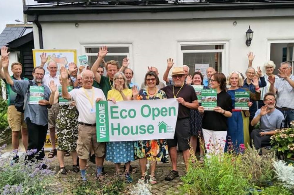 Picture of members of Greening steyning crowded together with an eco homes sign