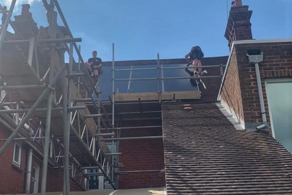 Picture of workmen installing the solar panels on the Springboard roof