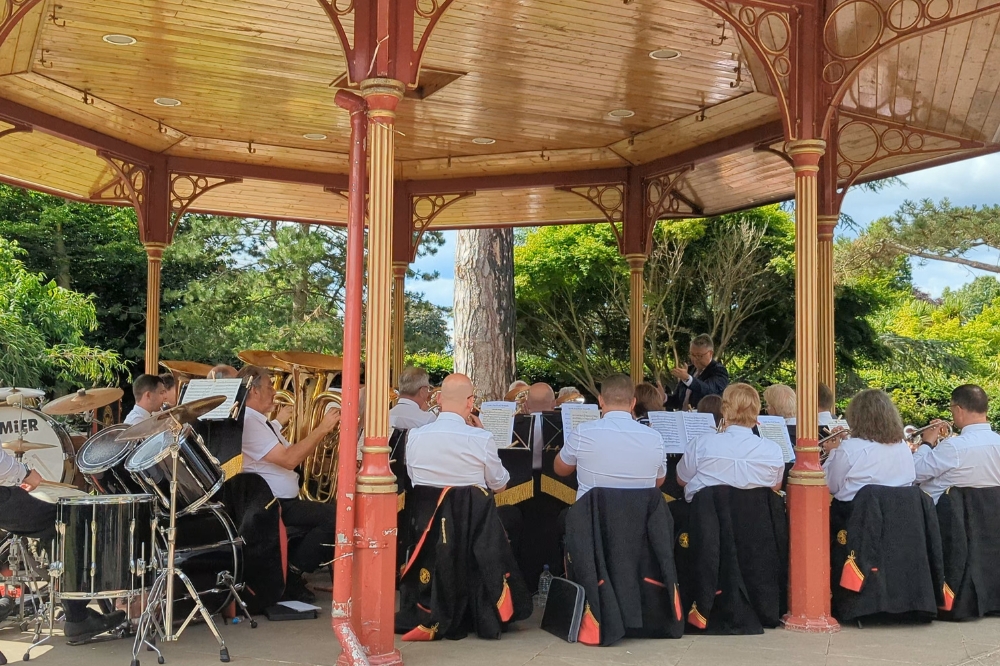 Image of a big band playing on a traditional bandstand on a sunny day in Horsham Park