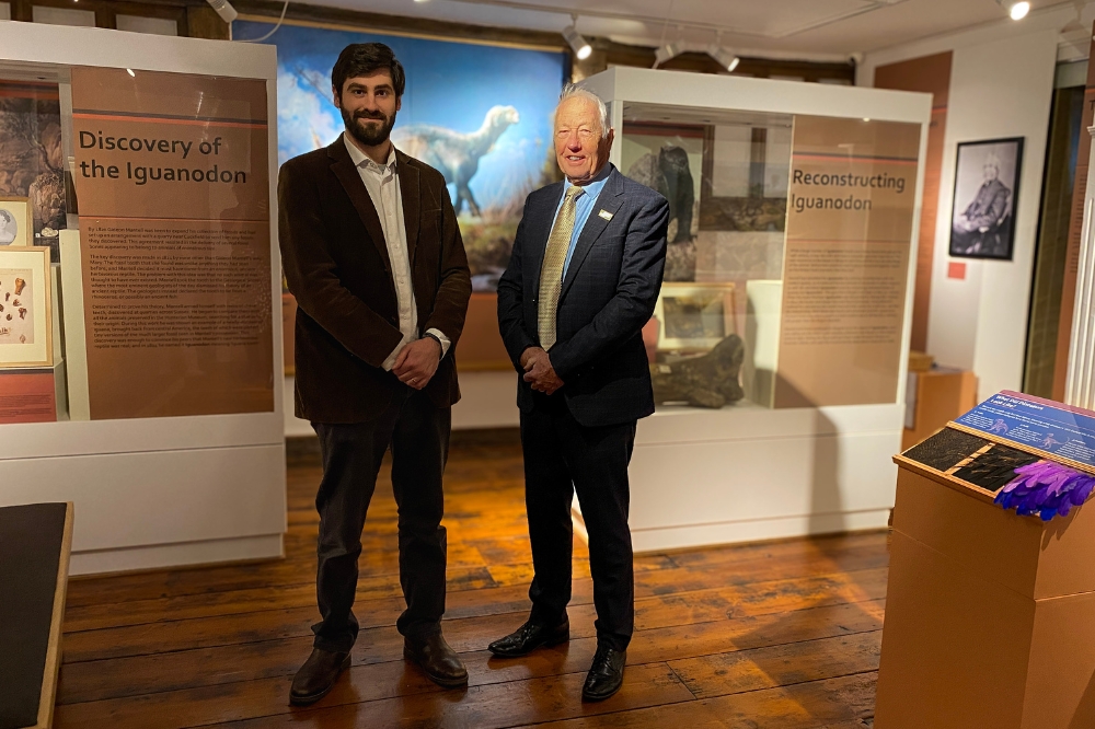 Horsham Museum Assistant Curator George Graham-Payne stands with Horsham District Council Cabinet Member for Leisure and Culture Cllr David Skipp at the Museum's new Discovering Dinosaurs exhibition