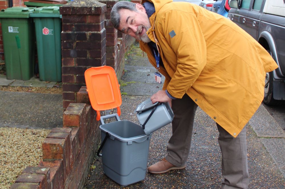 Horsham District Council Cabinet Member for Environment, Recycling and Waste Cllr Jay Mercer with a food caddy and food waste bin